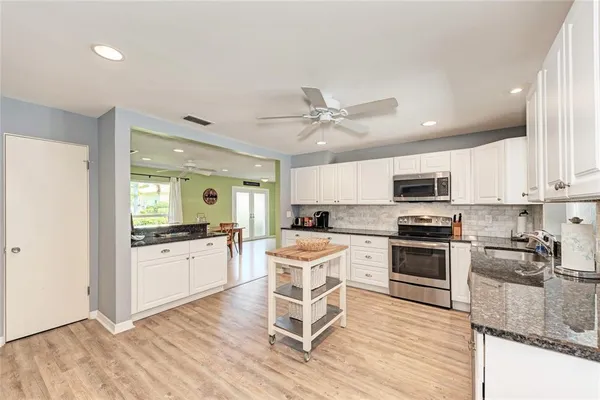 a bedroom with a bed chandelier and a window
