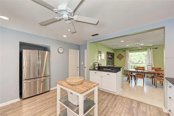 a bedroom with a bed and a flat tv screen on dresser