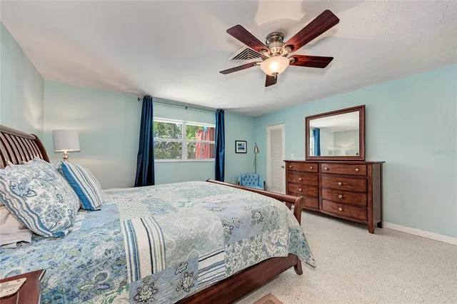 a bedroom with a bed and a television