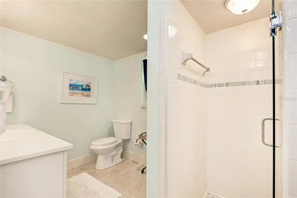 a bedroom with a bed and a lamp on the dresser