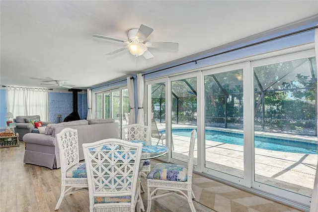 a living room with furniture a flat screen tv and a large window