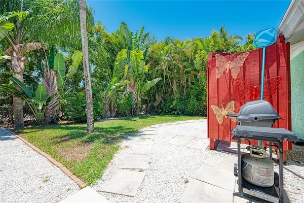 a view of a house with a yard and potted plants