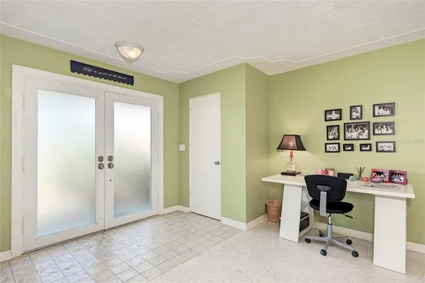 a view of a workspace with furniture and a window