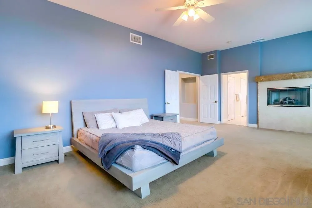 3646 Hidden Ridge Road Jamul, CA 91935 - Photo 21 of 43 a bedroom with a bed and a chandelier