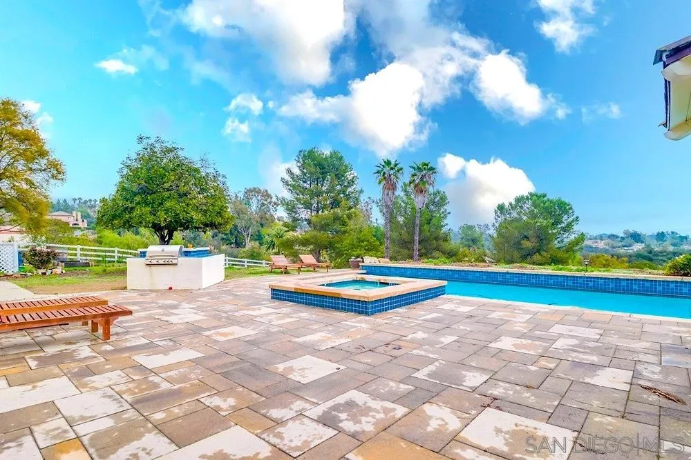 3646 Hidden Ridge Road Jamul, CA 91935 - Photo 34 of 43 a view of a swimming pool with an outdoor space and seating area