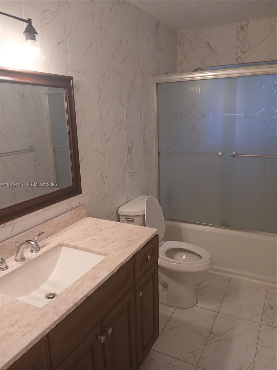 6471 Southwest 27th Street, Unit 2 Miramar, FL 33023 - Photo 25 of 41 a bathroom with a sink a toilet and mirror