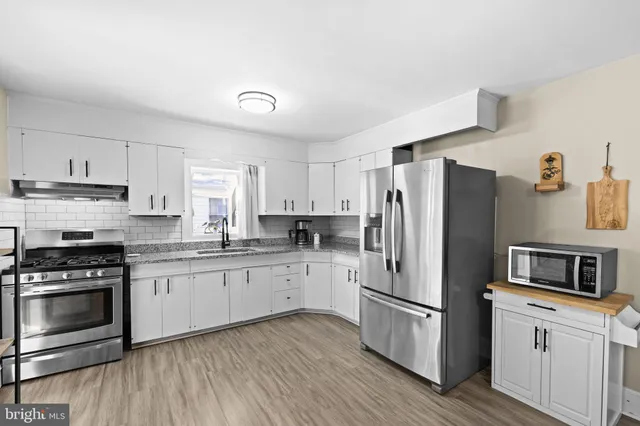 a kitchen with a refrigerator stove and sink