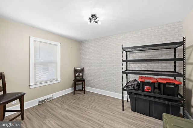 a view of room with furniture and wooden floor