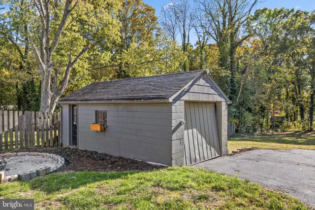 a front view of house with yard and trees around