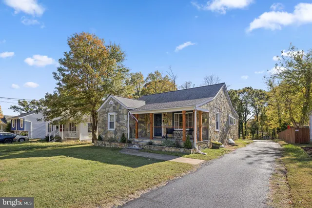 a front view of house with yard and trees around