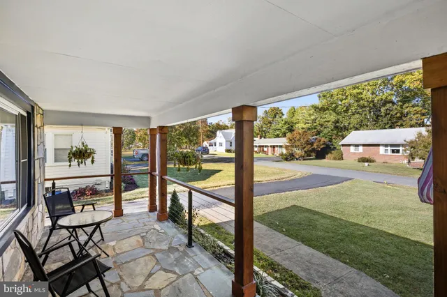 a view of a porch with furniture and garden