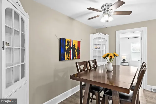a view of a dining room with furniture and a chandelier