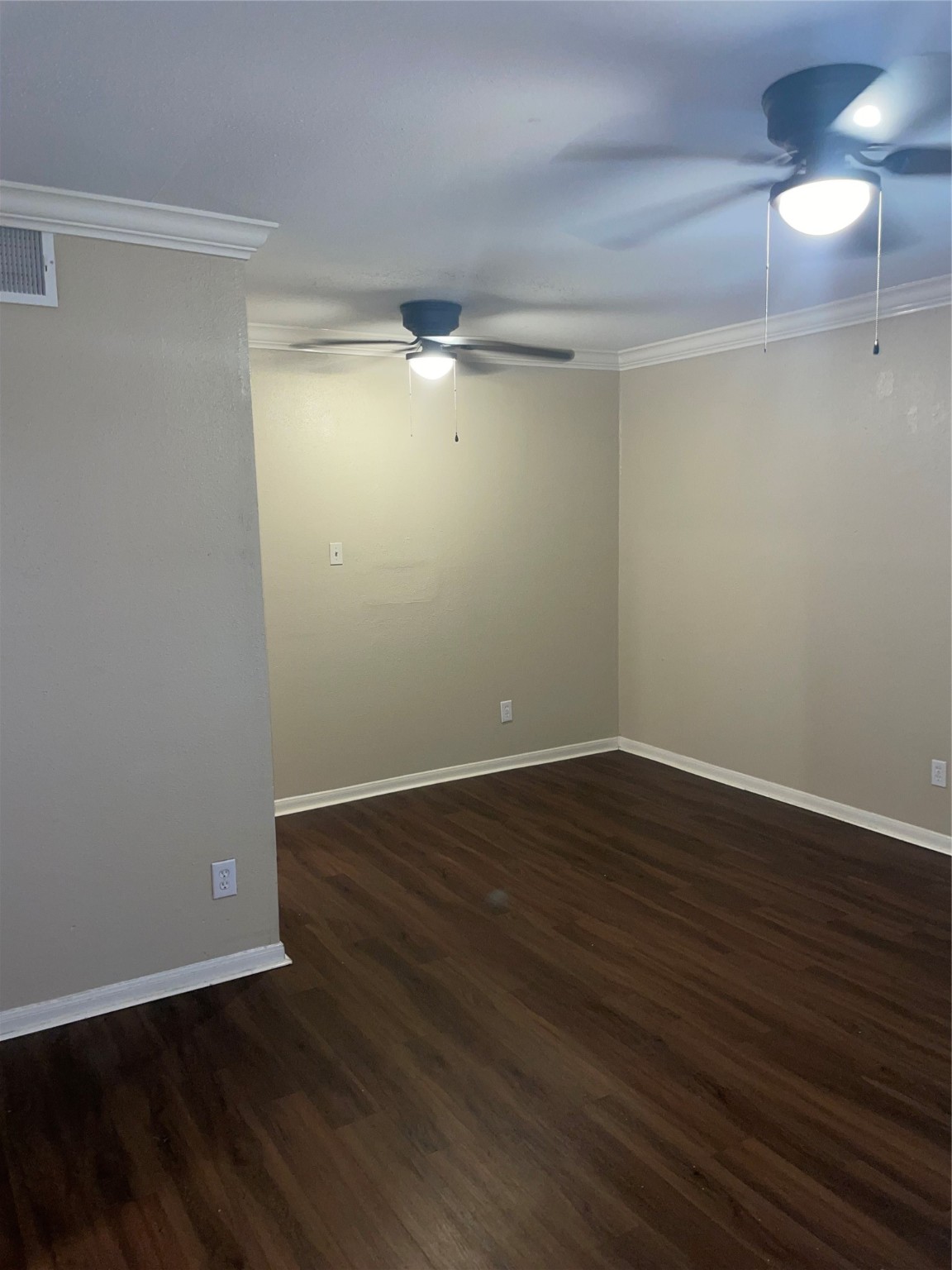 4710 Airport Boulevard, Unit 206 Houston, TX 77048 - Photo 2 of 17 a view of an empty room with wooden floor and a chandelier fan