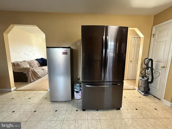 a kitchen with a refrigerator and cabinets