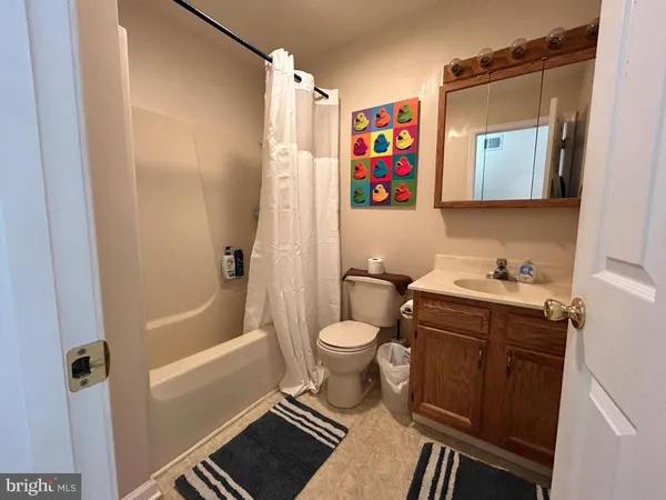 a bathroom with a toilet sink and shower