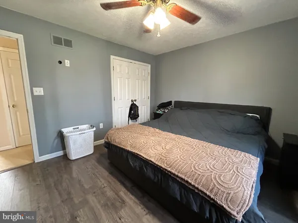 a spacious bedroom with a bed and a window