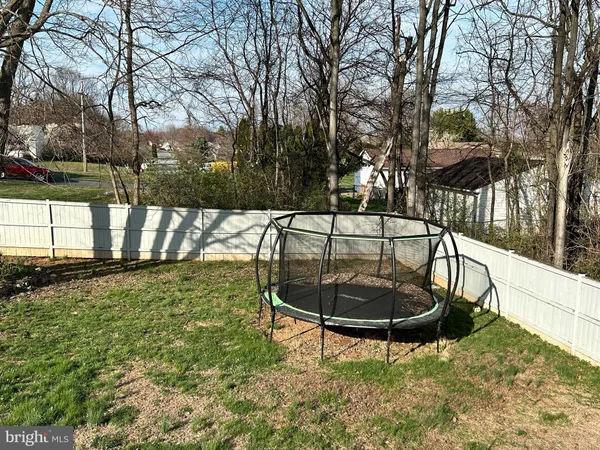 a view of a swimming pool with a patio and a yard
