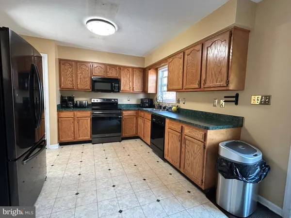 a kitchen with a sink stove and refrigerator