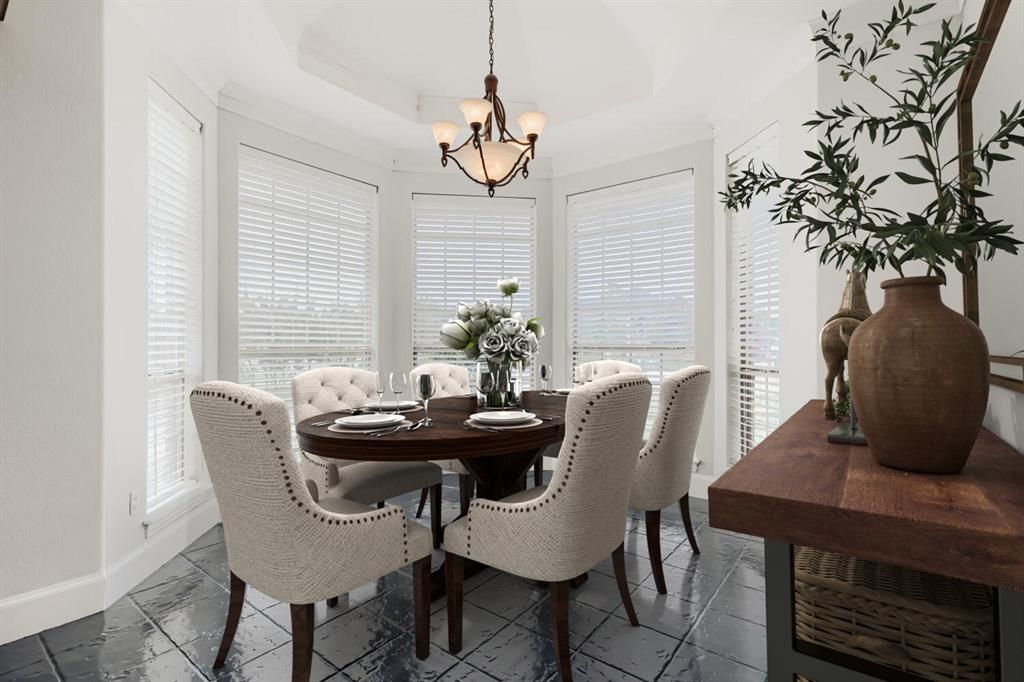603 Ash Street Pilot Point, TX 76258 - Photo 9 of 28 Bright dining area featuring a bay window with white blinds, a recessed ceiling, an ornate chandelier, and dark-toned tile flooring
