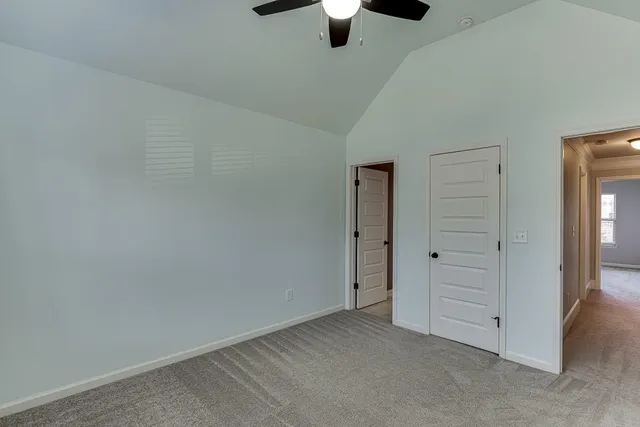 an empty room with closet and windows