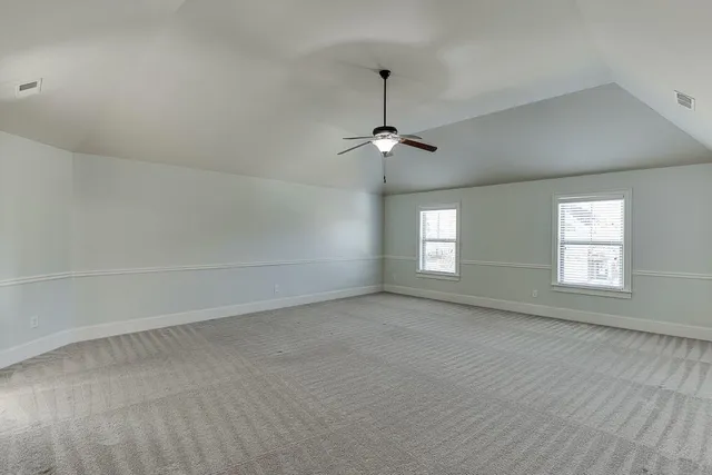 an empty room with a empty space and windows