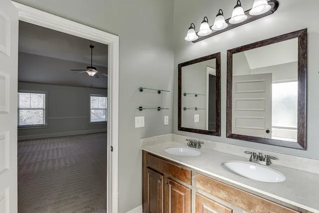 a bathroom with a sink double vanity and a mirror