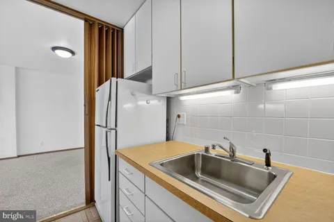 an empty room with windows and fireplace