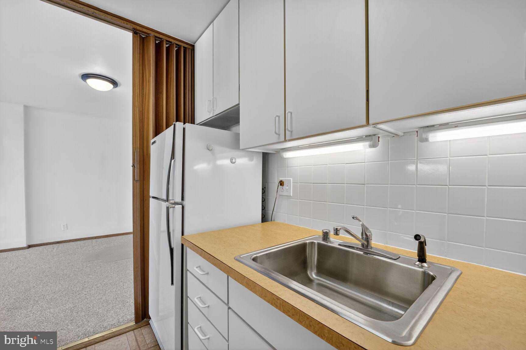 2475 Virginia Avenue Northwest, Unit 925 Washington, DC 20037 - Photo 11 of 45 a kitchen with a refrigerator and a sink