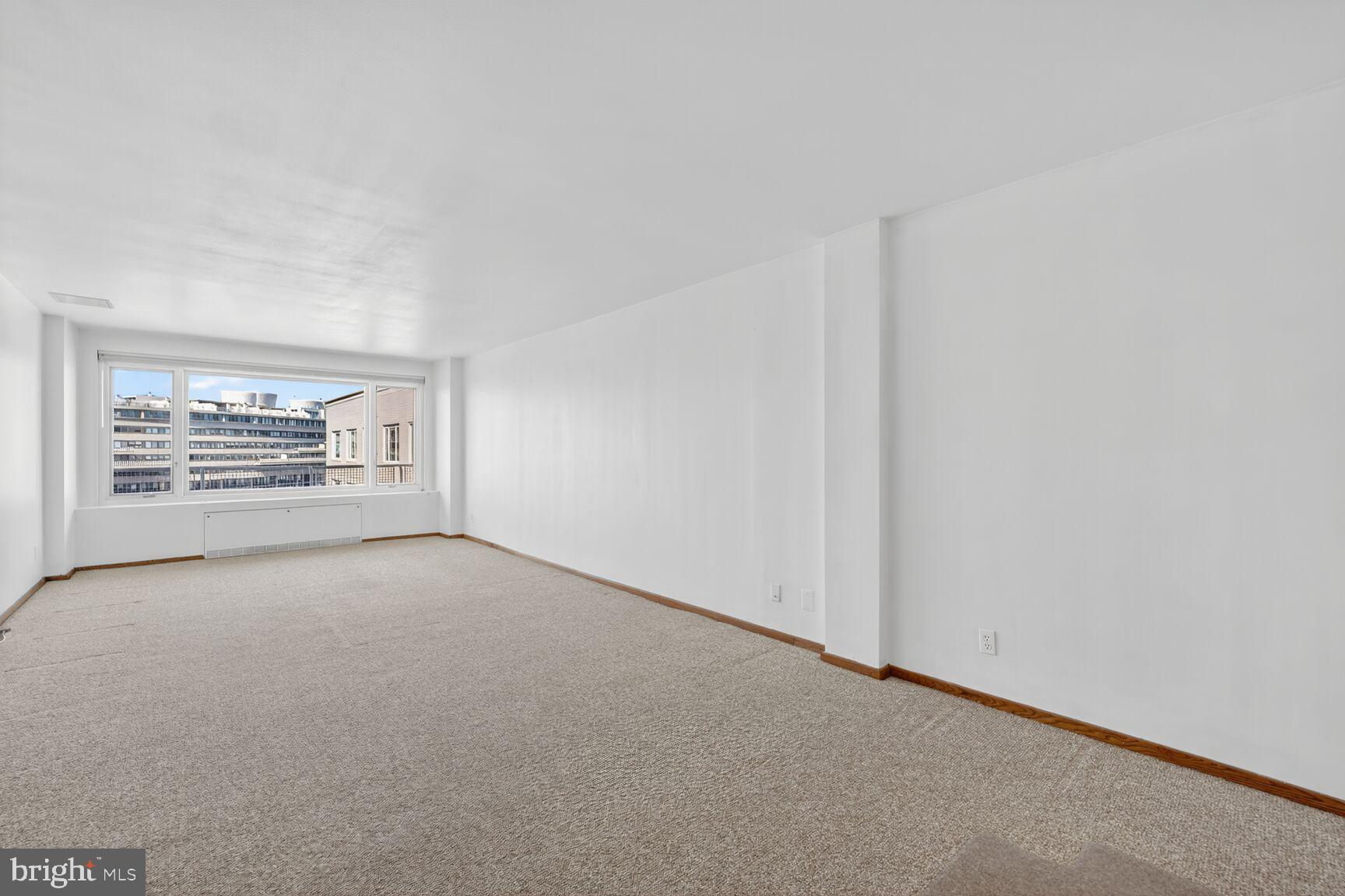 2475 Virginia Avenue Northwest, Unit 925 Washington, DC 20037 - Photo 12 of 45 an empty room with windows and fireplace