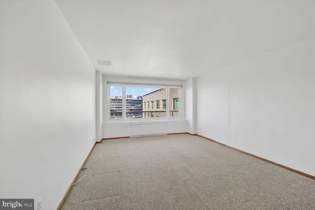 a view of an empty room and a window