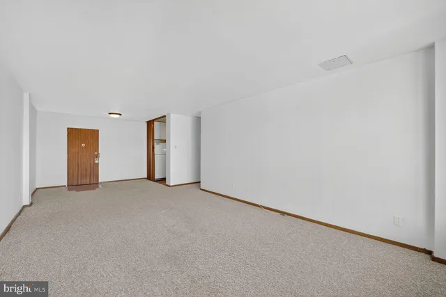 a view of an empty room with a fireplace