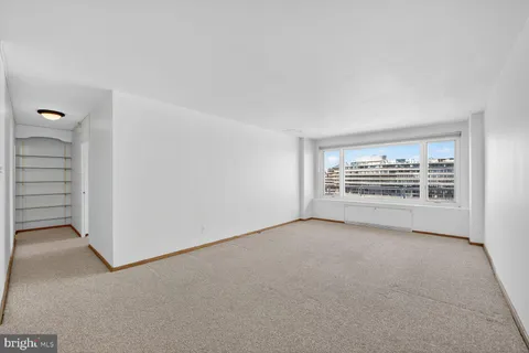 a view of an empty room and closet area