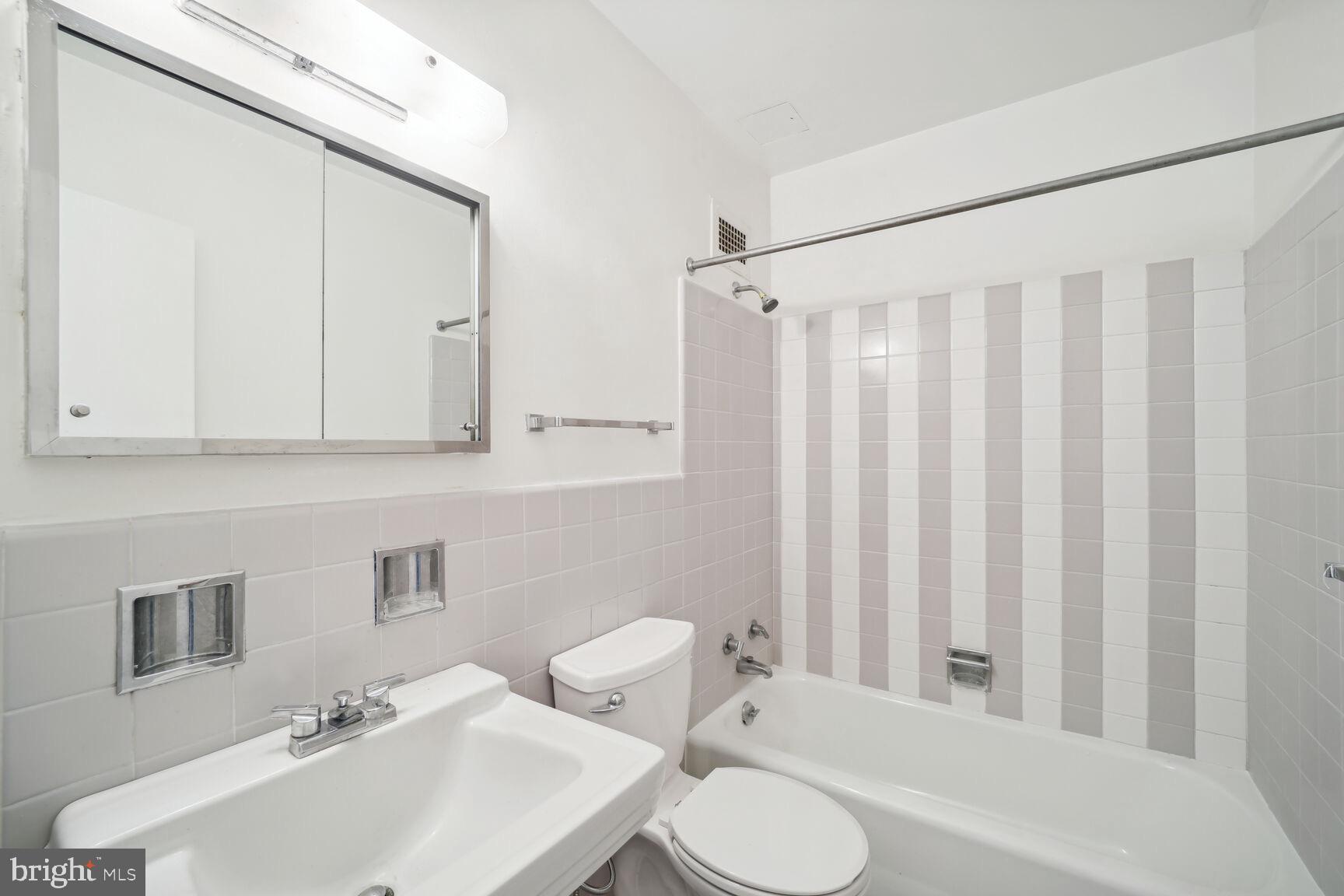 2475 Virginia Avenue Northwest, Unit 925 Washington, DC 20037 - Photo 22 of 45 a bathroom with a sink toilet and shower