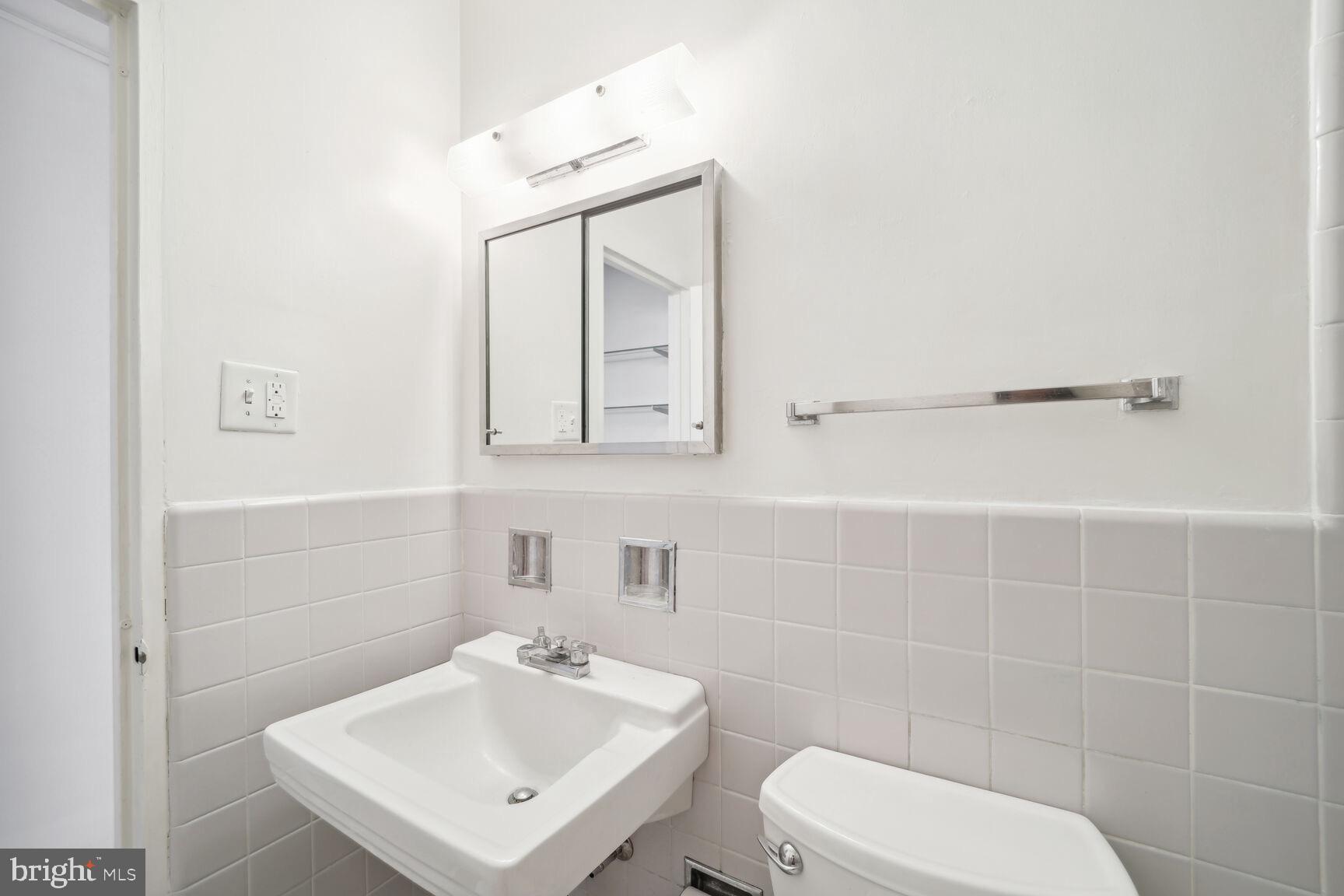 2475 Virginia Avenue Northwest, Unit 925 Washington, DC 20037 - Photo 23 of 45 a bathroom with a toilet sink and mirror
