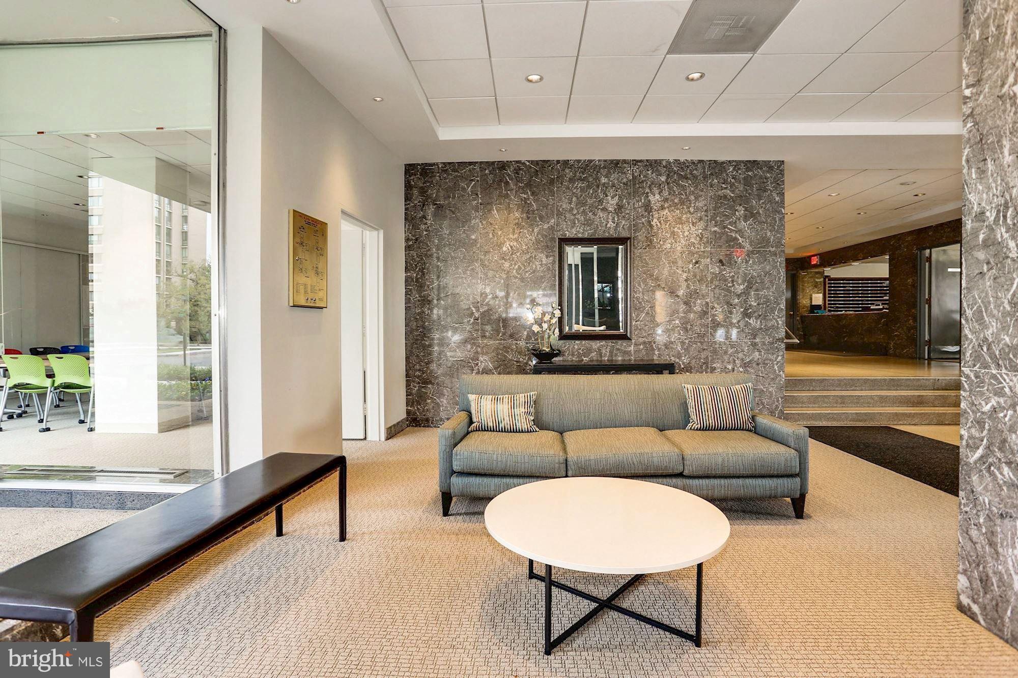 2475 Virginia Avenue Northwest, Unit 925 Washington, DC 20037 - Photo 5 of 45 a living room with furniture and a large window