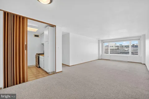 a kitchen with white cabinets and appliances
