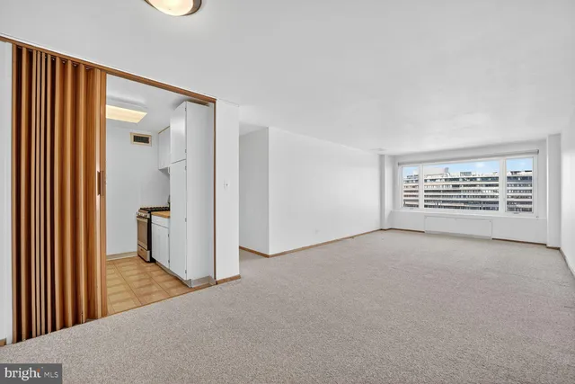 a kitchen with white cabinets and appliances