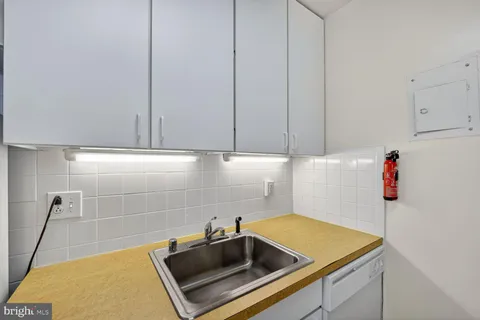 a kitchen with a refrigerator and a sink