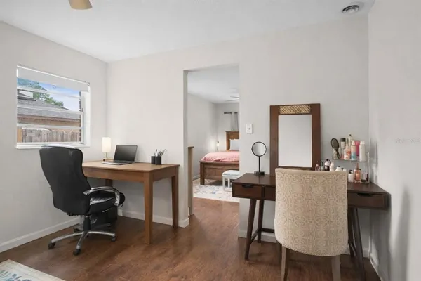 a view of a workspace with furniture and a workspace