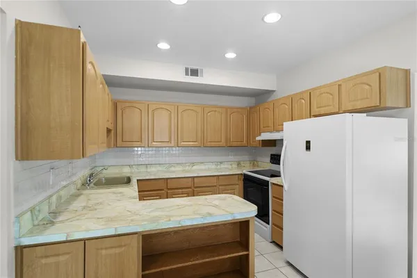 a kitchen with a refrigerator and a sink