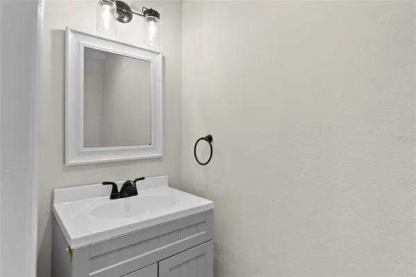 a bathroom with a sink vanity and mirror