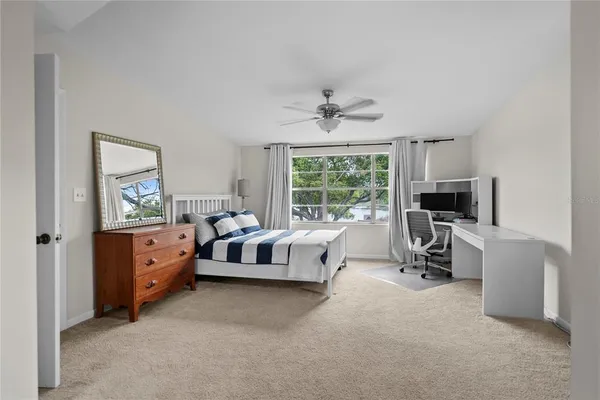 a large white bed with a fireplace and a window