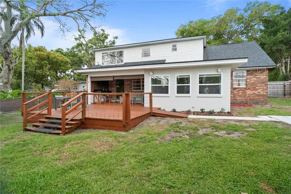 a view of a house with a yard and sitting area