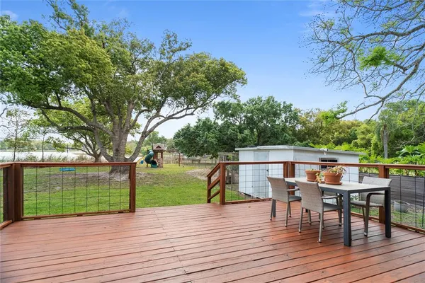 a view of a deck with table and chairs and wooden floor
