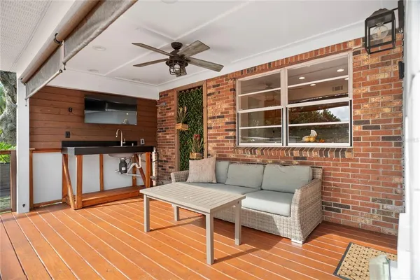 a outdoor living space with furniture and a flat screen tv