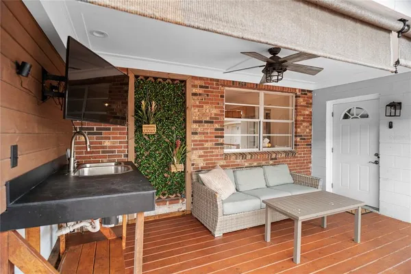 a balcony with furniture and wooden floor