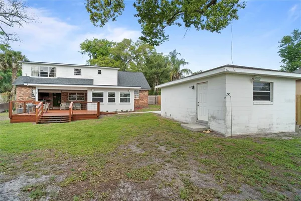 a view of an house with backyard space and balcony