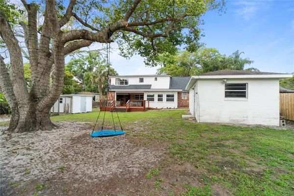 a view of a house with a backyard