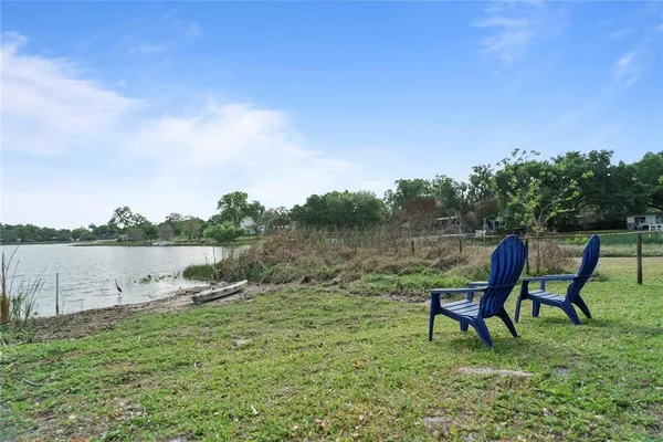 a backyard of a house with table and chairs