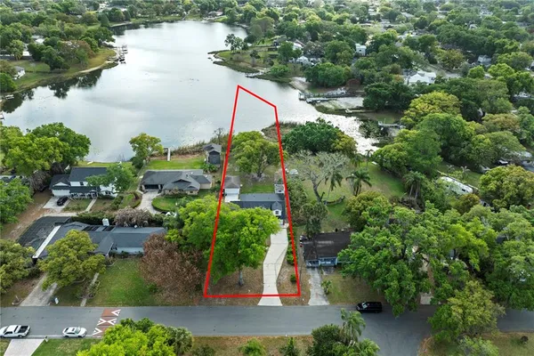 an aerial view of residential house with outdoor space and lake view
